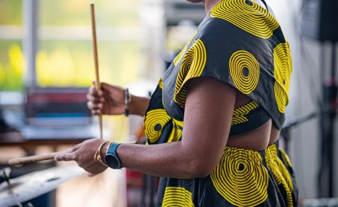 Darianna_singing_and_playing_claves_during_her_informative_presentation_of_Afro-Cuban_music.jpg