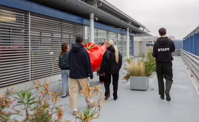 Une équipe d'artistes transporte une tomate géante